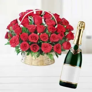 Basket arrangement of 40 red roses with bottle of champegne