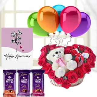 6 inch teddybear sitting in heart shape arrangement , 3 dairy milk silk chocolates, anniversary Greeting card with 5 blown balloons 