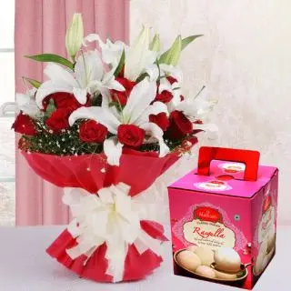 Exotic arrangement of red roses and white lilies with box of rasgullas