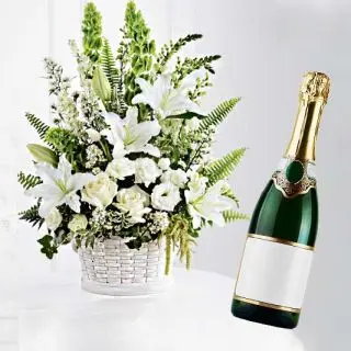 Basket arrangement of white lilies&pink roses with bottle of champegne