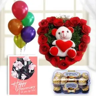 Heart shape arrangement of 15 red roses with teddybear sitting in it, 16 pcs rocher ferrero chocolates,  anniversary Greeting card with 5 blown balloons 