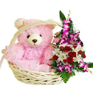 1 feet height teddy sitting in flower basket with mix flower arrangement 