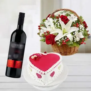 heart shape strawberry vanilla cocktail cake with basket arrangement of mix flowers with bottle of red wine 
