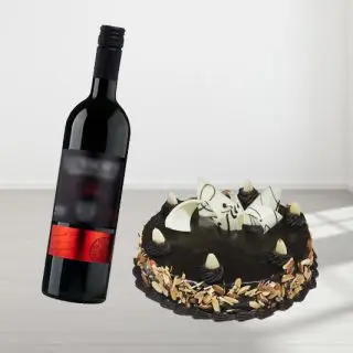  chocolate almonds cake with bottle of red wine