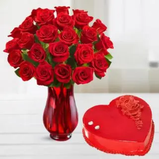 20 red roses arranged in glass vase with 1 kg heart shape strawberry cake 