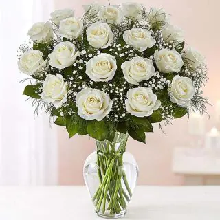 20 white roses arranged in glass vase 