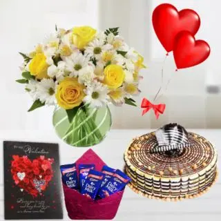Vase arrangment of exotic mix flowers , half kg premium quality butterscotch, 5 dairy milk chocolates,2 heart shape balloons with Greeting  card 
