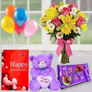 15 mix flowers arranged in glass vase , 1 feet height teddybear, set of 2 dairy milk silk, anniversary Greeting card with 5 blown balloons 