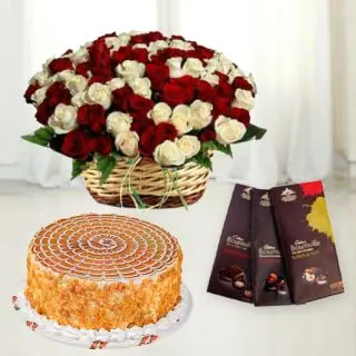 Basket arrangement of 50 red and white roses with butterscotch fresh cream cake with 3 bournville chocolates 