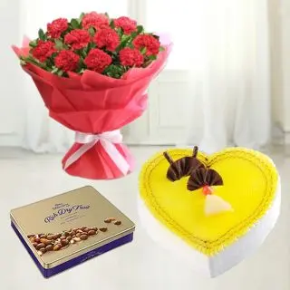 Box of cadburys premium chocolates with bunch of 12red carnations with heart shape pineapple fresh cream cake