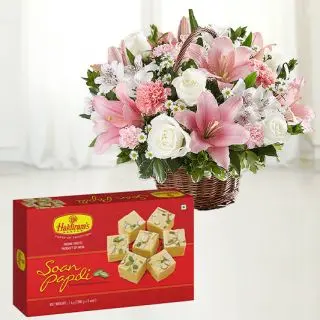 Exotic arrangement of lilies, anthuriums with roses and carnations with 1 kg soan papdi sweets