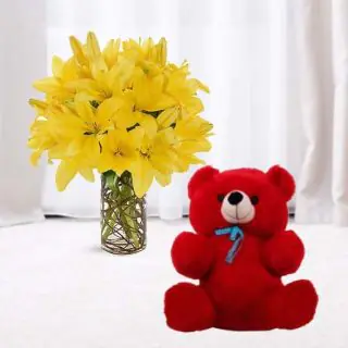 5 yellow lilies in glass vase with 6 inch red teddybear 