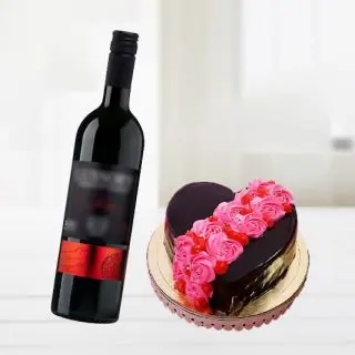 strawberry vanilla cocktail heart shape cake with bottle of red wine