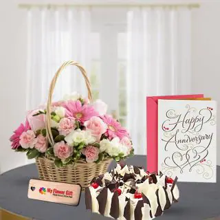 Basket Arrangement of 15 mix flowers with half kg white forest cake with anniversary card 