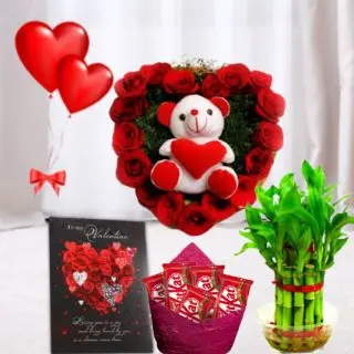 6 inch teddybear sitting in a heart shape arrangement of 15 red roses, pack of 5 perk chocolates, 6 inch height teddybear, 2 layer Lucky bamboo plant, 5 blown balloons with greeting card 