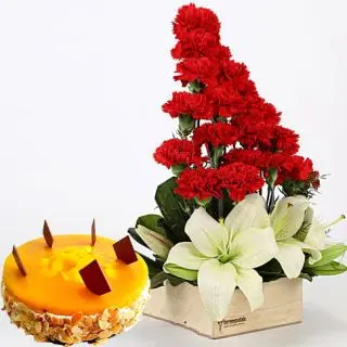 Exotic basket arrangement of lilies and carnations with 1 kg mango fresh cream premium quality cake