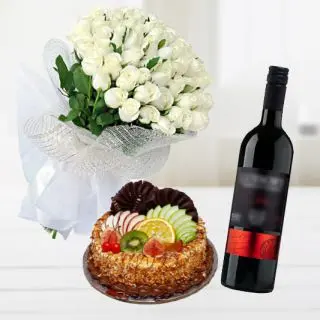 Bunch of 12 white roses with mix fruit premium quality cake with bottle of red wine 