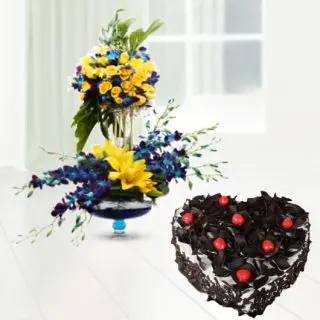 2 storey designer floral arrangement of orchids, lilies and roses  with 2 feet height along with heart shape black forest cake 