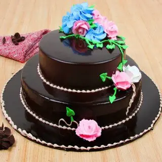 2 tier designer chocolate cake with floral topping 