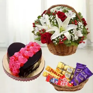 Exotic basket arrangement of lilies and roses with  heart shape chocolate cake with basket of assorted chocolates