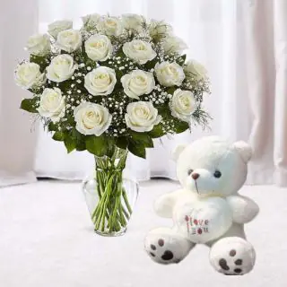 12 white roses in glass vase with cute 1 feet height teddy bear