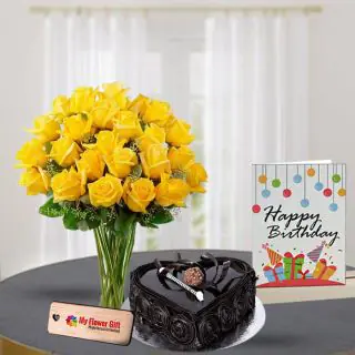 Yellow lilies in glass vase with 1 kg chocolate heart shape cake with Birthday greeting card 