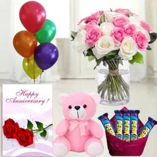 15 red and pink roses arranged in glass vase,  1feet height pink  teddybear , set of 5 perk  chocolates, anniversary greeting card with 5 blown balloons 