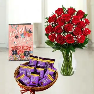 20 red roses arranged in glass vase ,  basket of dairy milk chocolates, birthday greeting card 