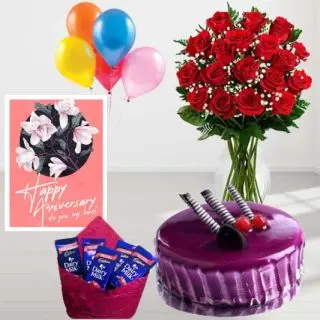 15 red roses in glass vase, black currant premium quality cake, Pack of 5 dairy milk chocolates, anniversary greeting card, with 5 blown balloons