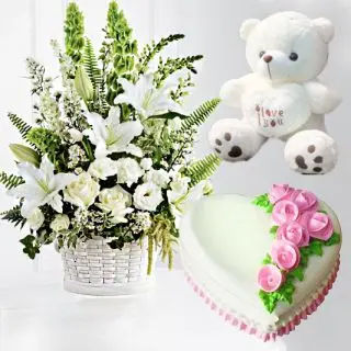 Exotic Basket arrangement of lilies and roses with heart shape chocolate cake with 1 feet height teddybear
