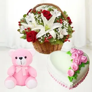 Basket arrangement of exotic lilies with fresh roses with heart shape vanilla fresh cream cake with 2 feet height teddybear