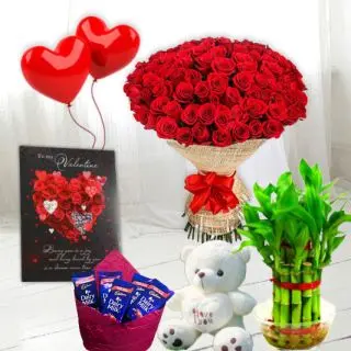 Basket of 15 red roses, 16 pcs rocher ferrero chocolates, 6 inch height teddybear, 2 layer Lucky bamboo plant, 5 blown balloons with greeting card 
