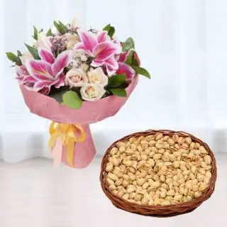 Bunch of exotic mix flowers with basket of pistachio
