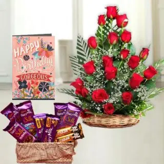 Basket arrangement of 20 red roses ,  Basket of 7 dairymilk silk 2 Fivestar chocolates, birthday greeting card 