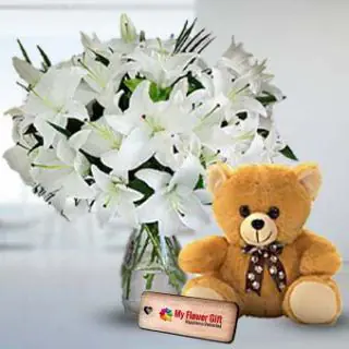 8 white lilies in glass vase with 1 feet height teddybear 
