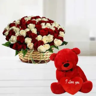 Beautiful basket arrangement of 50 red and white roses with 6 inch red teddy bear 