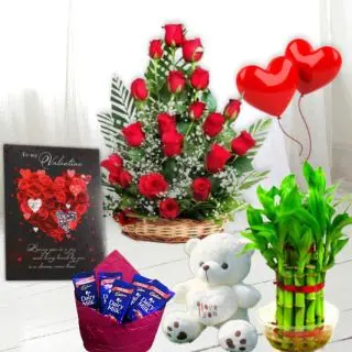 Heart shape arrangement of 50 red roses, 16 pcs rocher ferrero chocolates, 6 inch height teddybear, 2 layer Lucky bamboo plant, 5 blown balloons with greeting card
