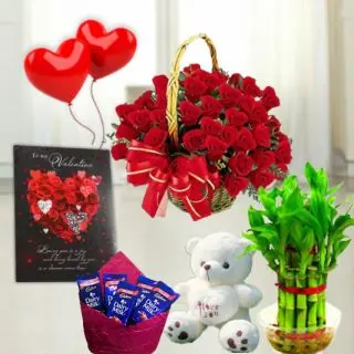 6 inch teddybear arranged in heart shape arrangement of 15 red roses, set of 3 bournville chocolates, 6 inch height teddybear, 2 layer Lucky bamboo plant, 5 blown balloons with greeting card 