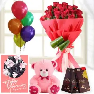 15 red roses bouquet, 6 inch pink teddybear, 3 bournville dark chocolates,  anniversary Greeting card with 5 blown balloons 