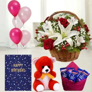Basket of 2 white lilies, with 10 red roses, 6 inch teddybear, set of 5 dairy milk chocolates, birthday greeting card with 5 blown balloons