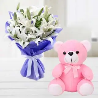 Bunch of 8 white lilies with a cute 6 inch pink colour teddy bear 