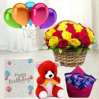Basket of 15 red and yellow roses ,  6 inch teddybear, set of 5 dairy milk chocolates,birthday  greeting card with 5 blown balloons 