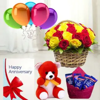 Basket of 15 red and yellow roses ,  6 inch teddybear, set of 5 dairy milk chocolates, anniversary  greeting card with 5 blown balloons 