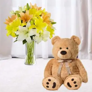 Exotic vase Arrangement of 10 yellow and white lilies with 1 feet height teddy bear 
