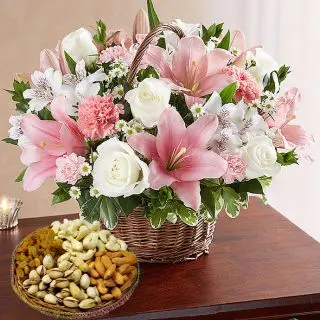 Basket of exotic mix flowers with basket of assorted dryfruits