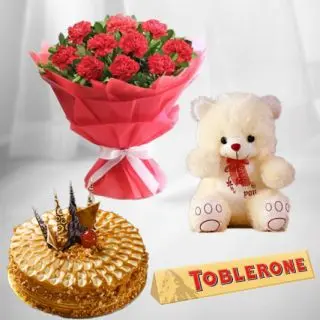 Bunch of 10 red carnations with premium quality butterscotch cake with 6 inch teddybear with toblerone chocolate 