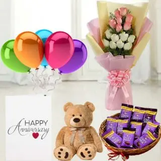 Bunch of 15 pink and white roses,  6 inch teddy bear, Basket of  dairy milk chocolates, anniversary   greeting card with 5 blown balloons 