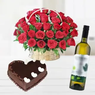 Rich looking basket arrangement of 50 red roses with heart shape chocolate truffle cake with bottle of white wine
