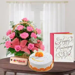 Basket Arrangement of 10 pink roses with half kg orange cake with anniversary card 