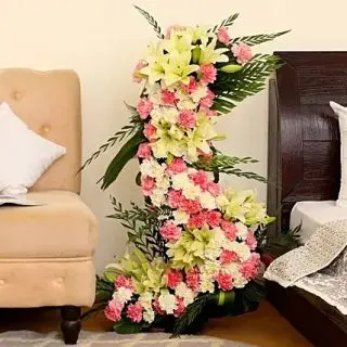 4 feet height arrangement of 100 pink and white carnations with white lilies 